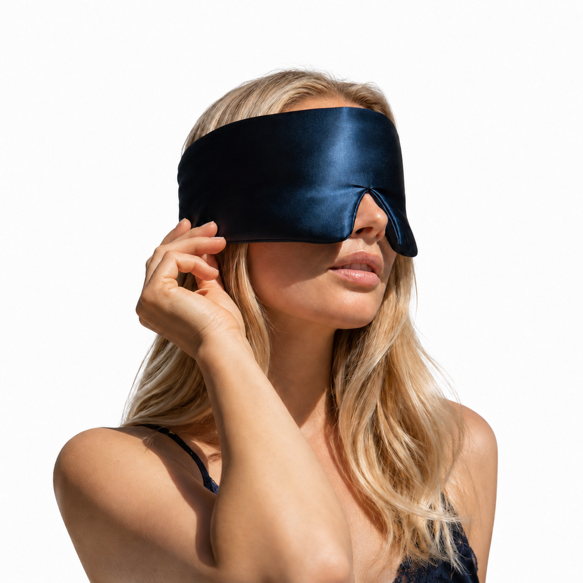 Navy mulberry silk sleep mask worn over the eyes